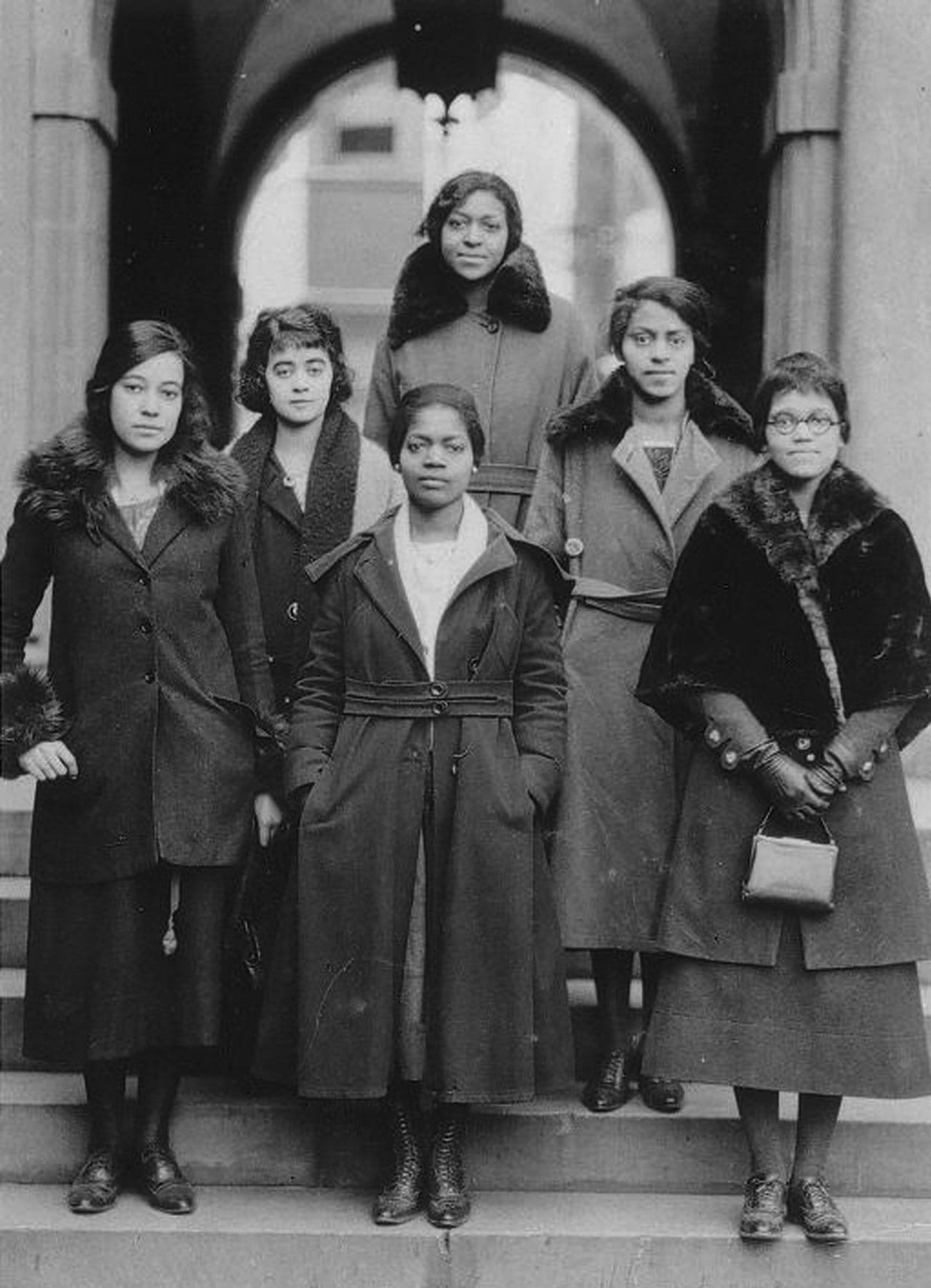 Women standing on steps.