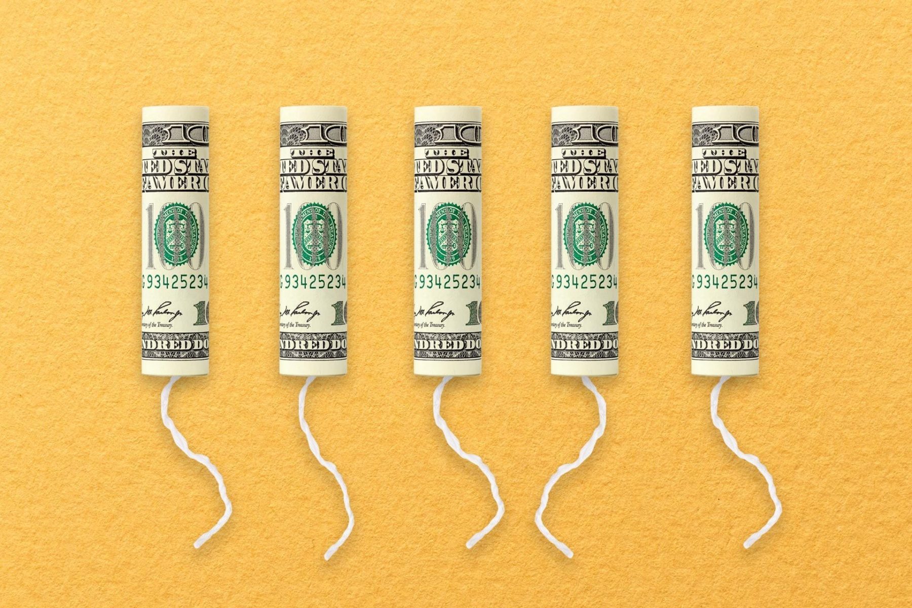 A row of tampons with $100 bills on them.