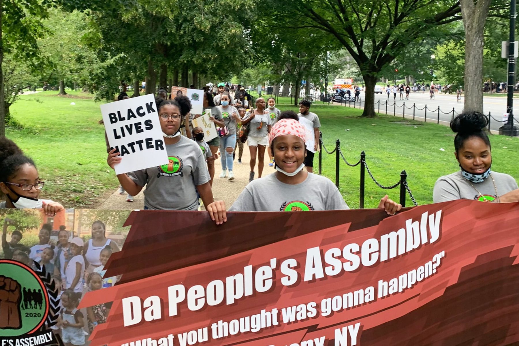 A group of children and parents from the Bronx, holding a banner that reads Da People's Assemblage, attending the 2020 March on Washington to protest.