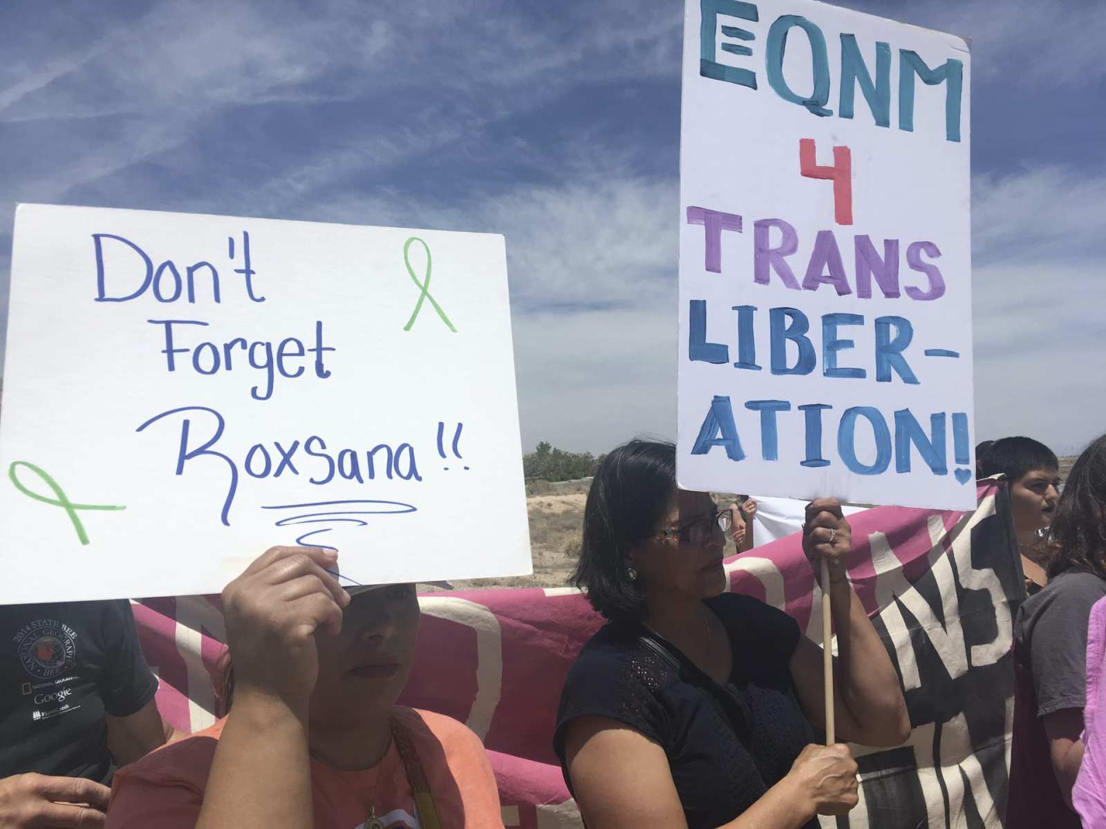 Protesters hold up signs as they gather outside a U.S. Immigration and Customs Enforcement office in Albuquerque, New Mexico, on Wednesday, June 6, 2018. Immigrant and LGBT rights advocates held the protest in response to the death of Roxsana Hernandez, a Honduran transgender woman who was in ICE custody and showing signs of pneumonia, dehydration and complications associated with HIV when she was admitted to an Albuquerque hospital last month.