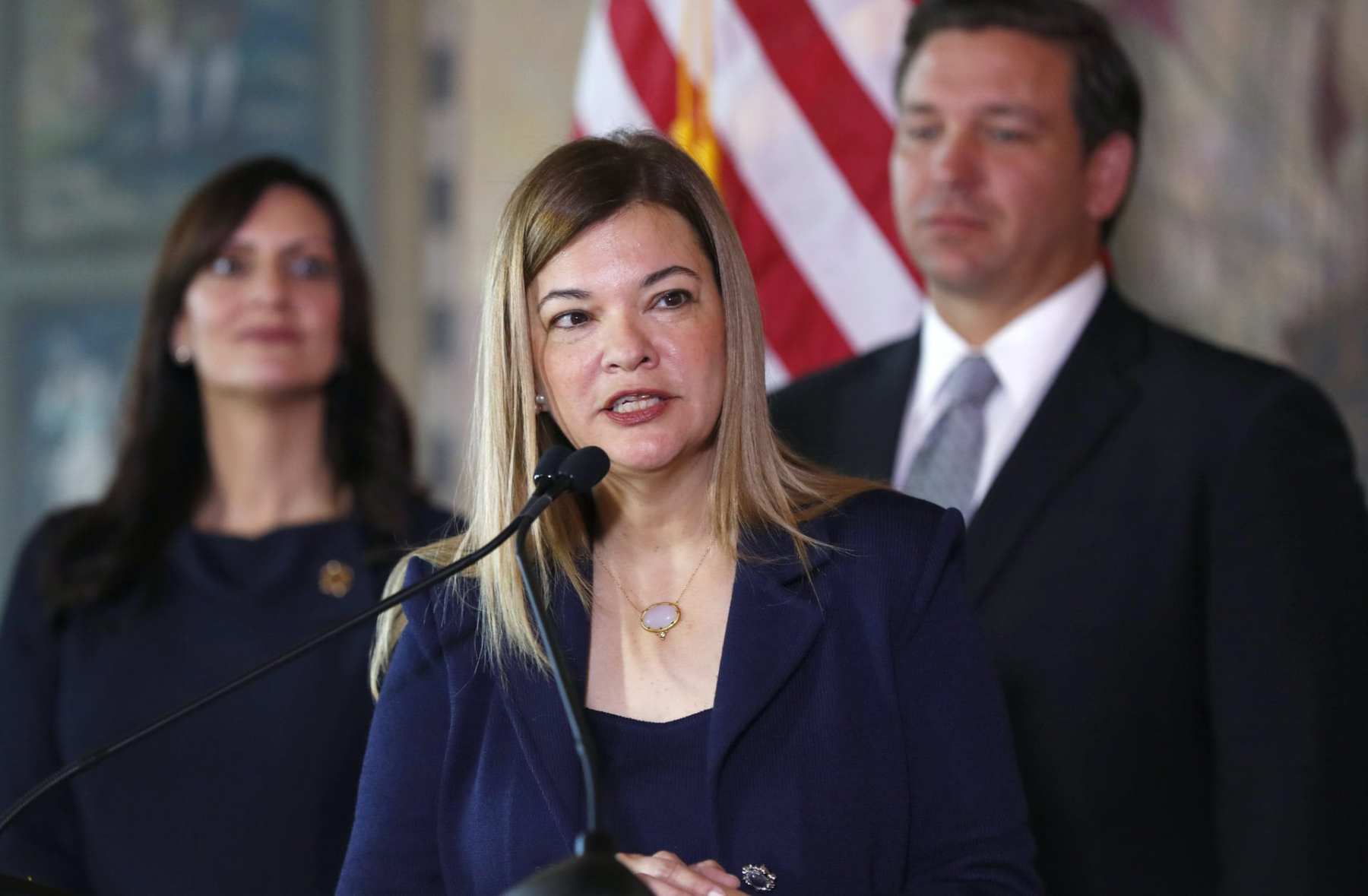 Barbara Lagoa, center, Governor Ron DeSantis' pick for the Florida Supreme Court, speaks after being introduced, as DeSantis and Lieutenant Governor Jeanette Nunez, left, look on, Wednesday, Jan. 9, 2019, in Miami. (AP Photo/Wilfredo Lee)