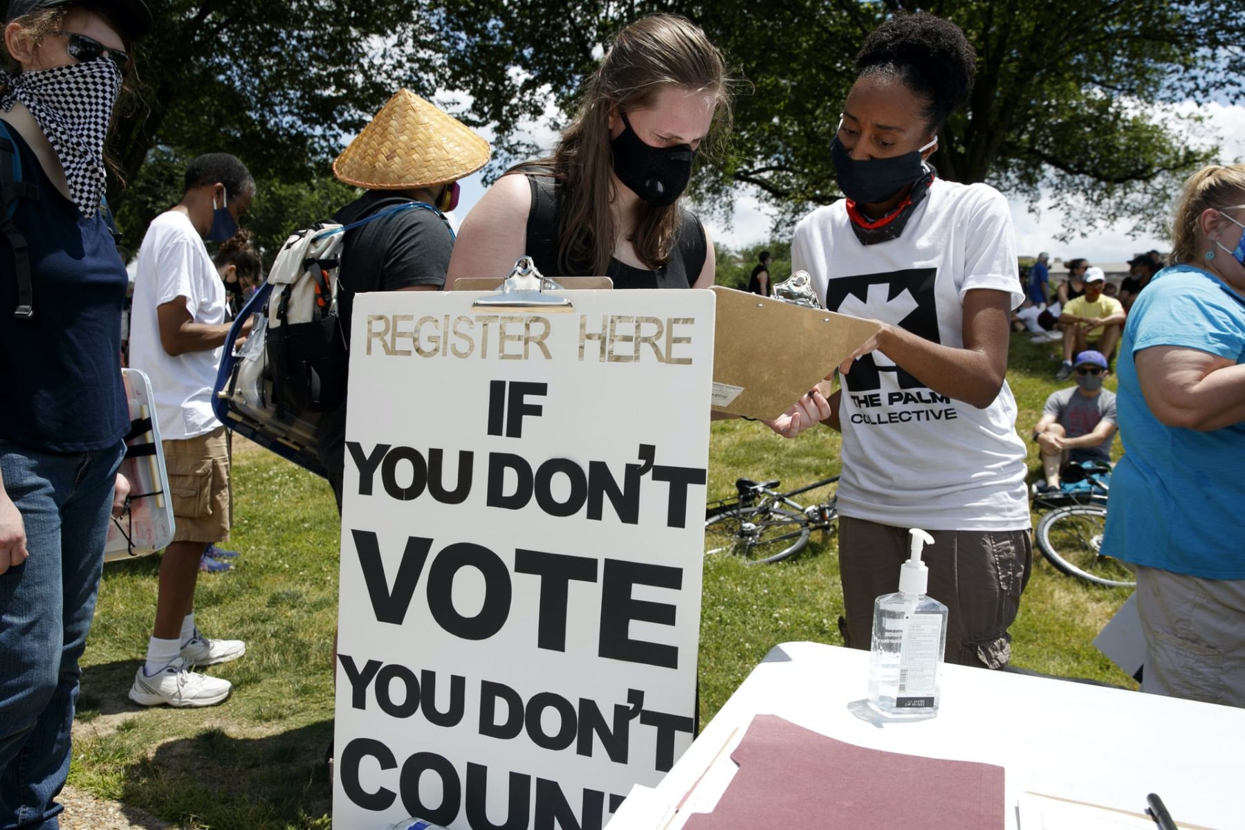 Birdie Addison, 18, of Germantown, Md., left, registers to vote for the first time while being helped by Kysten Thomas, of Washington, ahead of a march from the National Museum of African American History and Culture to the Lincoln Memorial, in Washington on Friday, June 19, 2020, to mark Juneteenth, the holiday celebrating the day in 1865 that enslaved black people in Galveston, Texas, learned they had been freed from bondage, more than two years after the Emancipation Proclamation. (AP Photo/Jacquelyn Martin)