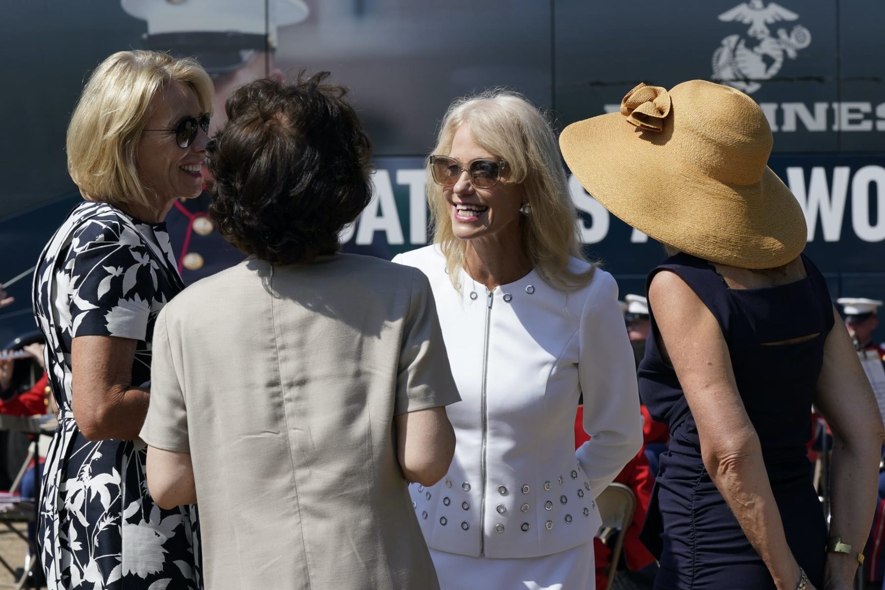 Kellyanne Conway, one of President Donald Trump's most influential and longest serving advisers, speaks with Education Secretary Betsy Devos, left, and Transportation Secretary Elaine Chao, second from left, at an event with First Lady Melania Trump, in front of the White House in Washington, Monday, Aug. 24, 2020. Conway announced Sunday that she would be leaving the White House at the end of the month, citing a need to spend time with her four children. (AP Photo/J. Scott Applewhite)