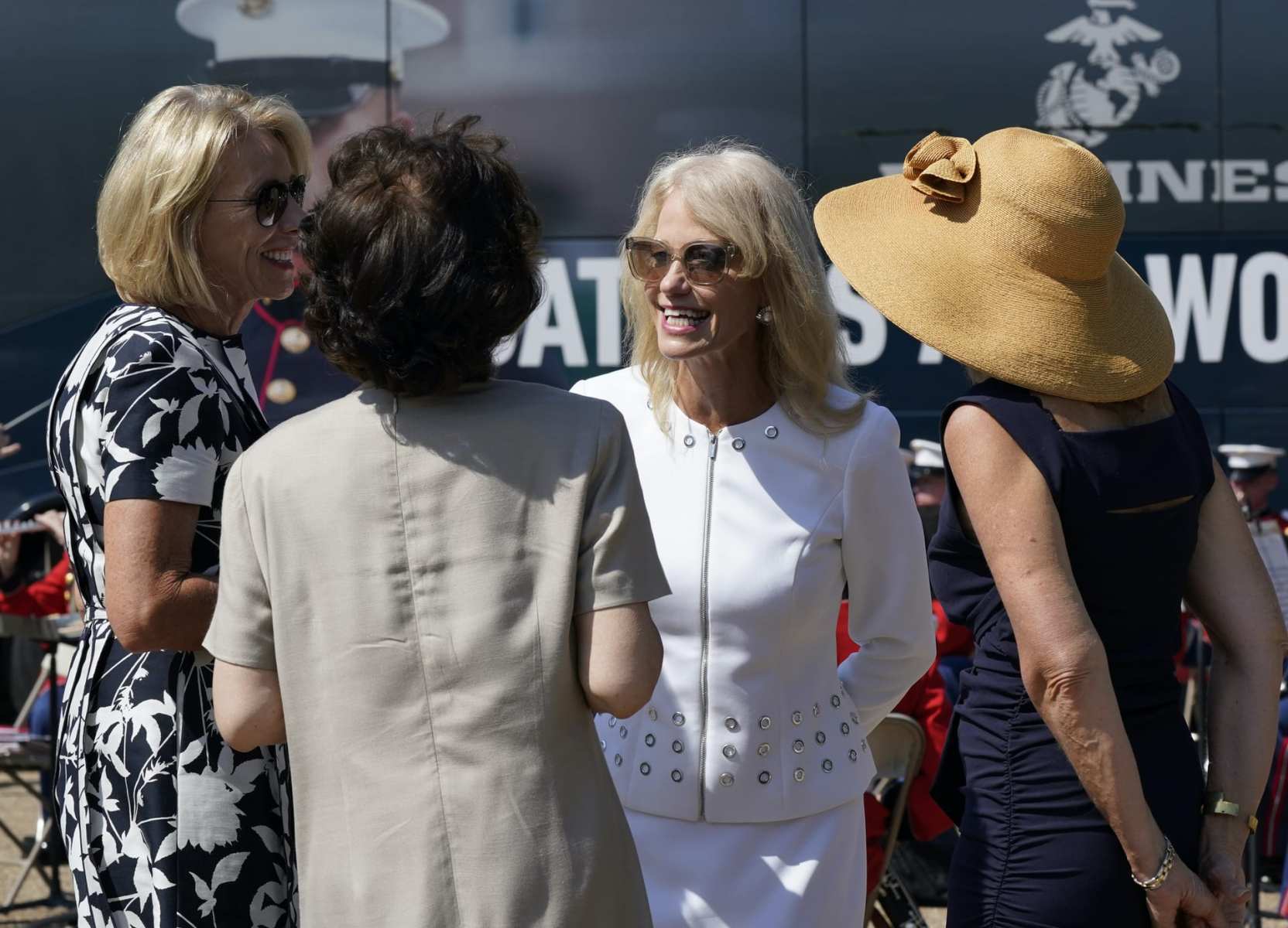 Kellyanne Conway, one of President Donald Trump's most influential and longest serving advisers, speaks with Education Secretary Betsy Devos, left, and Transportation Secretary Elaine Chao, second from left, at an event with First Lady Melania Trump, in front of the White House in Washington, Monday, Aug. 24, 2020. Conway announced Sunday that she would be leaving the White House at the end of the month, citing a need to spend time with her four children. (AP Photo/J. Scott Applewhite)