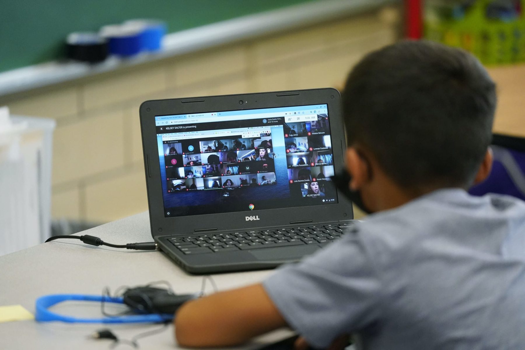 Justin Castilla works on a laptop in a classroom in Newlon Elementary School early Tuesday, Aug. 25, 2020, which is one of 55 Discovery Link sites set up by Denver Public Schools where students are participating in remote learning in this time of the new coronavirus from a school in Denver.