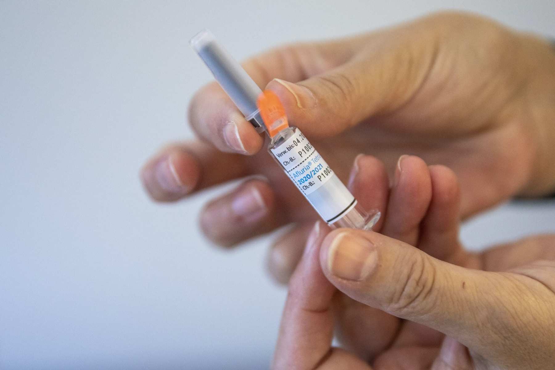 A person holding a flu vaccine.