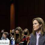 Amy Coney Barrett sits at a desk in front of the Senate Judiciary Committee.