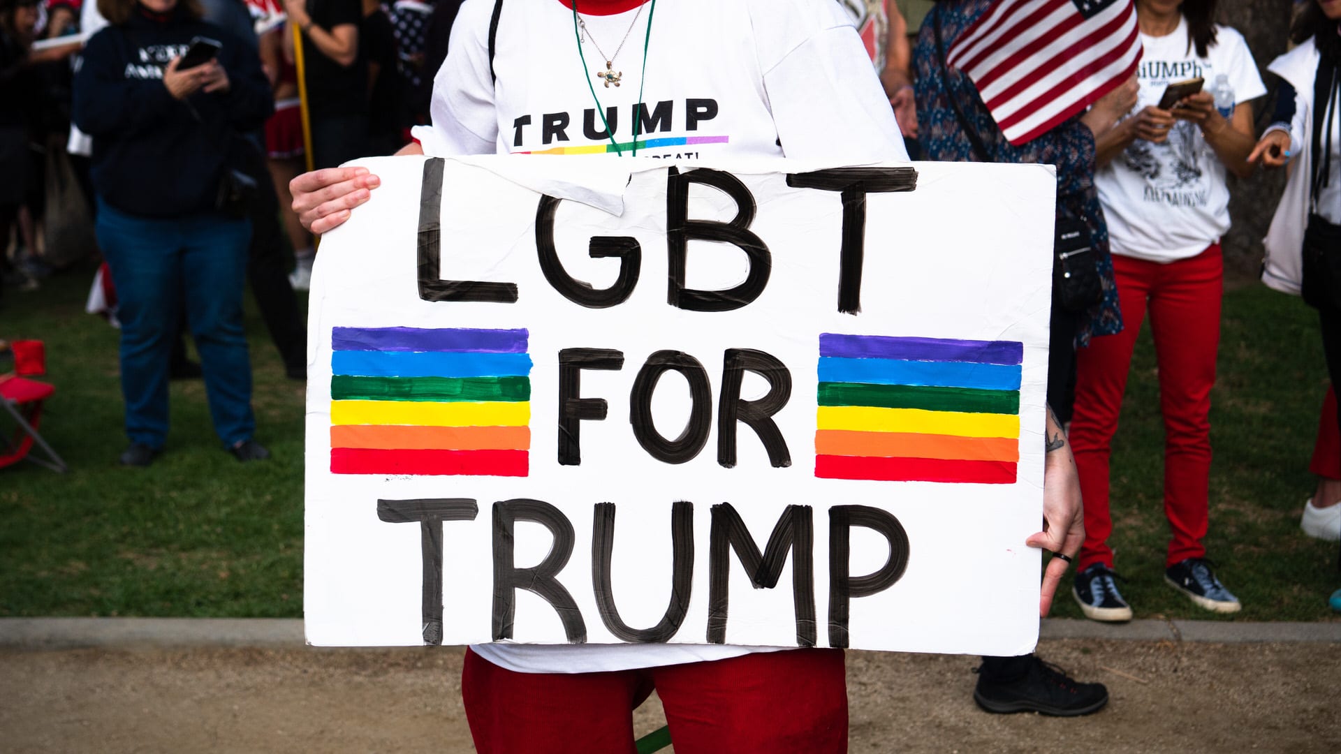A person holding a sign that reads "LGBT for Trump"