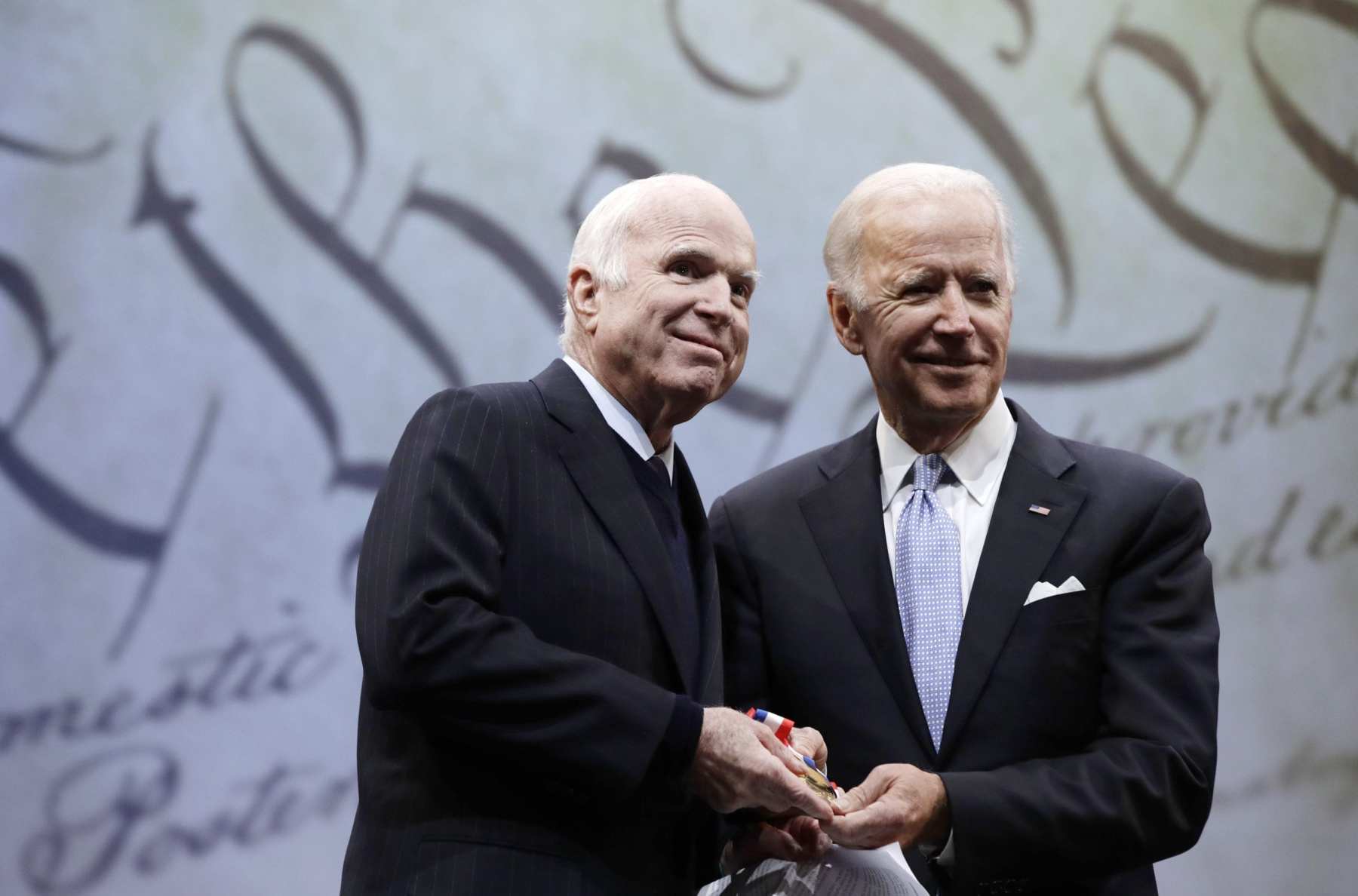 Sen. John McCain and Joe Biden together on stage.