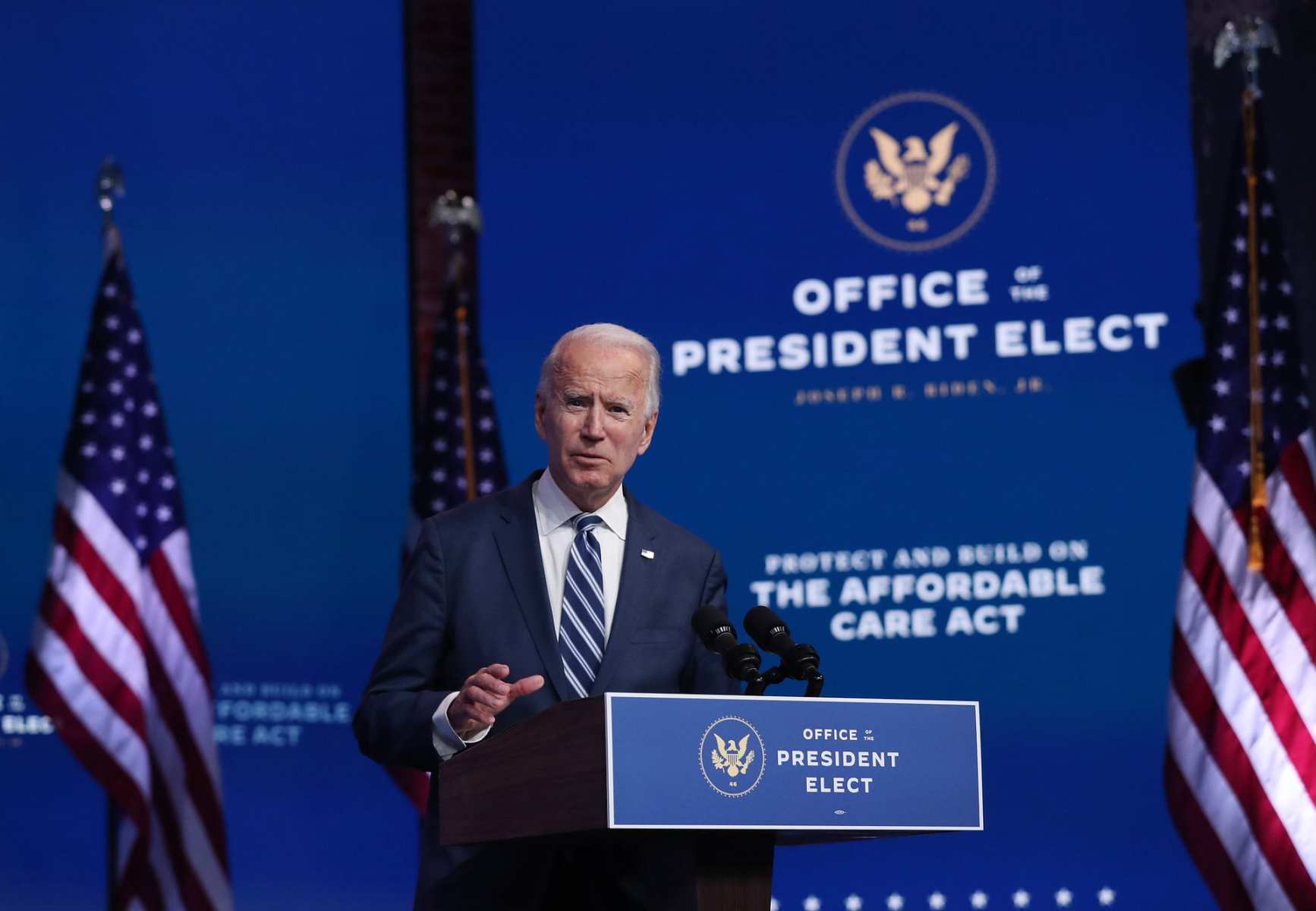 Joe Biden stands at a podium.