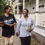 Adrianne Shropshire, executive director of BlackPAC, walking with a canvasser.