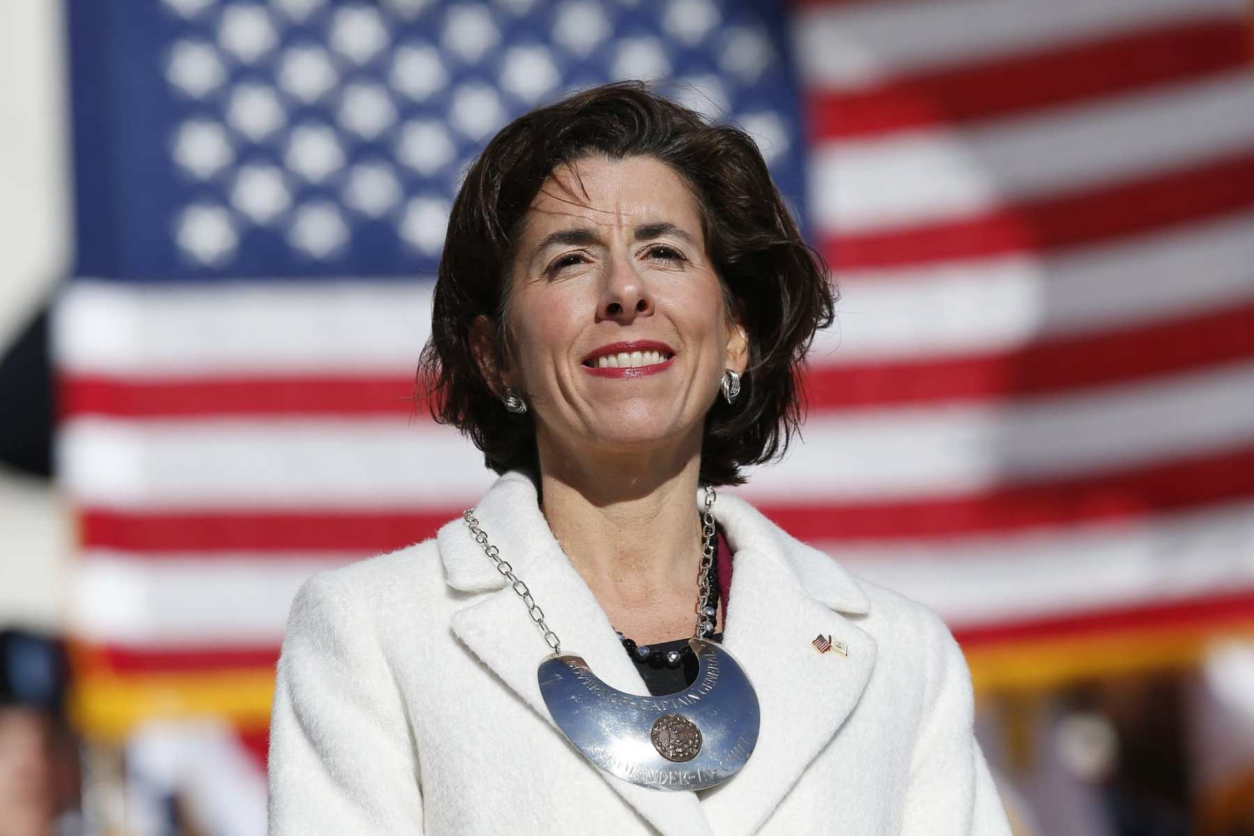 Gina Raimondo stands on the State House.