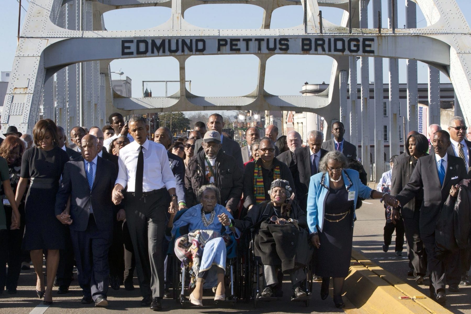 President Barack Obama walks over the Edmund Pettus Bridge with a group on the 50th anniversary of 