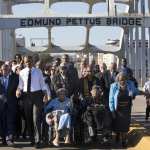 President Barack Obama walks over the Edmund Pettus Bridge with a group on the 50th anniversary of 