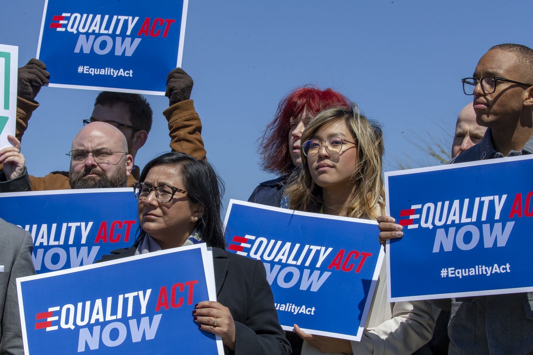 Protesters stand in support of a introduction of the Equality Act.