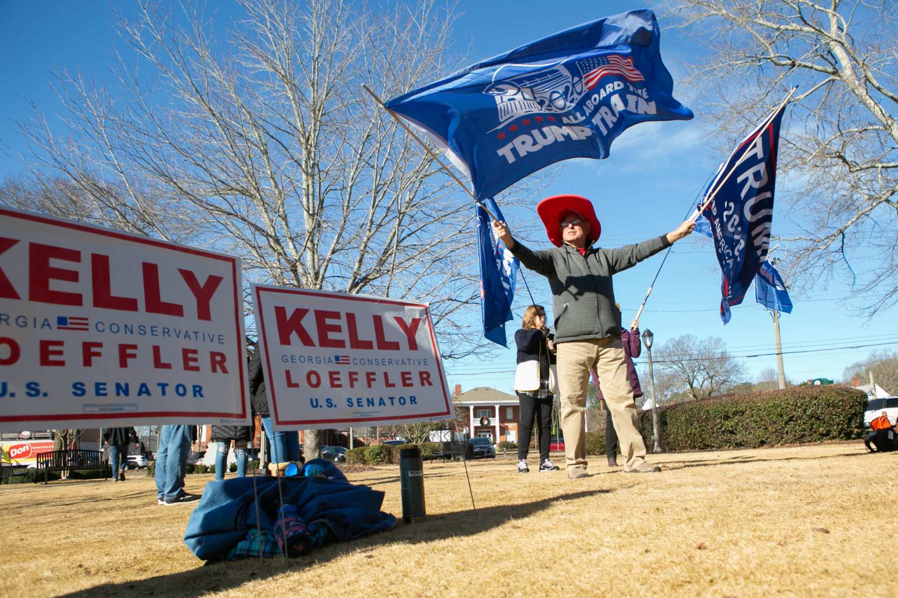 WOODSTOCK, GA - DECEMBER 29: Gary White waves Trump flags during a Senate Firewall campaign rally for Sen. Kelly Loeffler (R-GA) at The Park at City Center on December 29, 2020 in Woodstock, Georgia. Loeffler faces Democratic Senate candidate Raphael Warnock in the runoff election that will determine control of the U.S. Senate. With a week until the January 5th runoff election, candidates continue to campaign throughout Georgia. (Photo by Jessica McGowan/Getty Images)