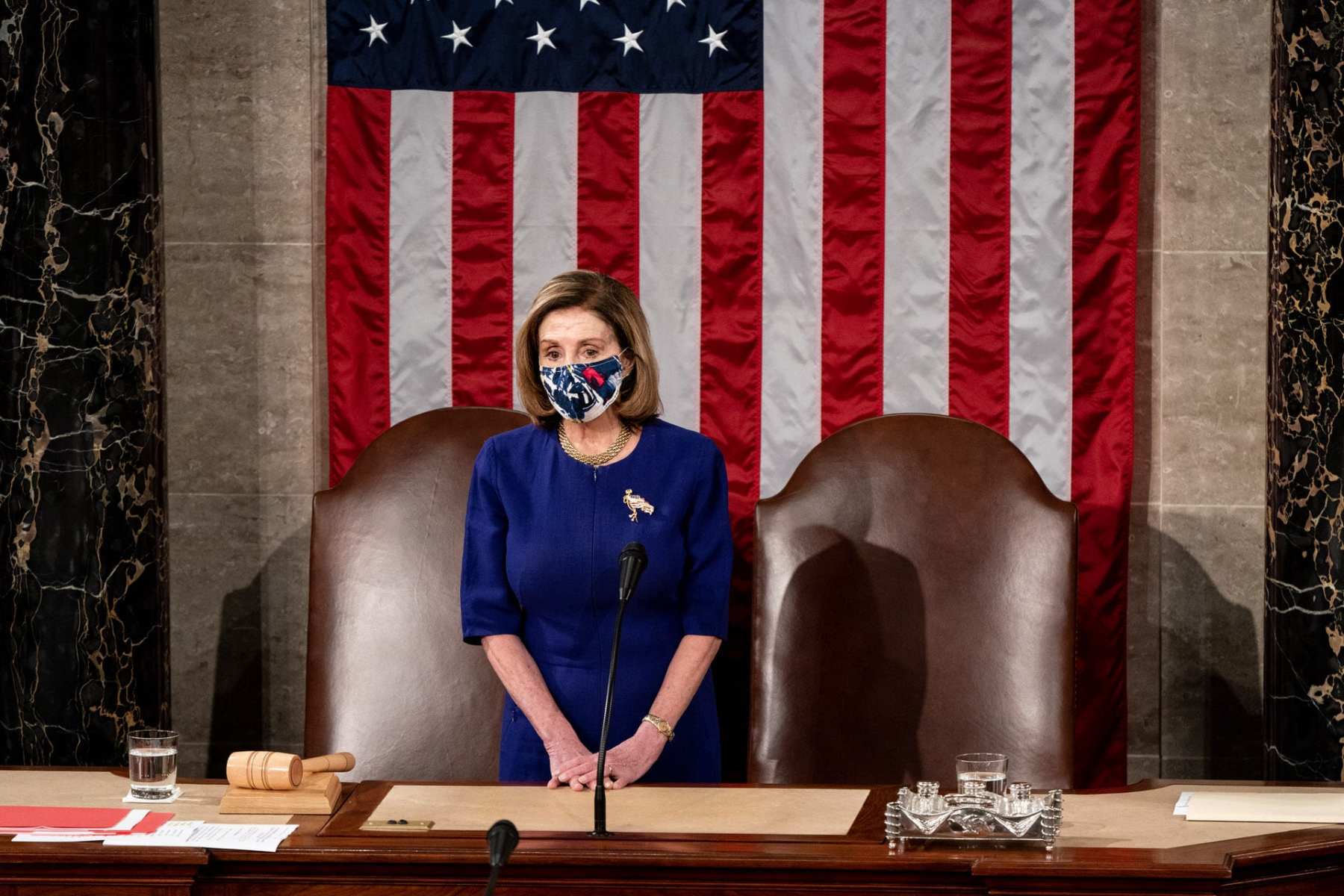 House Speaker Nancy Pelosi waits at the podium in a joint session of Congress.