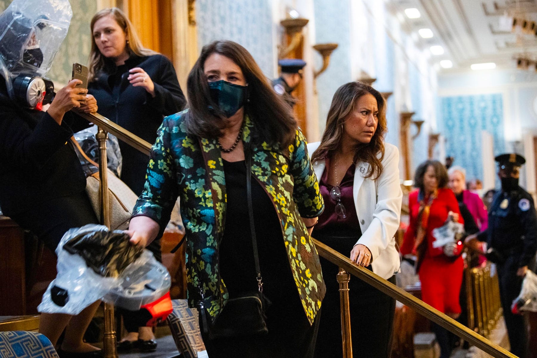 House members are ushered out the chamber during the breach at the Capitol.