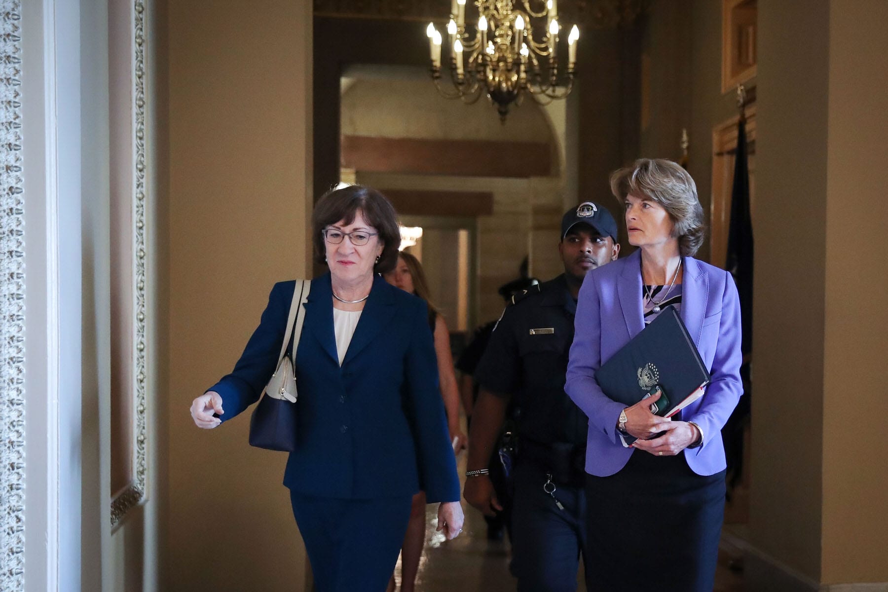 Sen. Susan Collins (R-ME) and Sen. Lisa Murkowski (R-AK) walk together down a hallway.