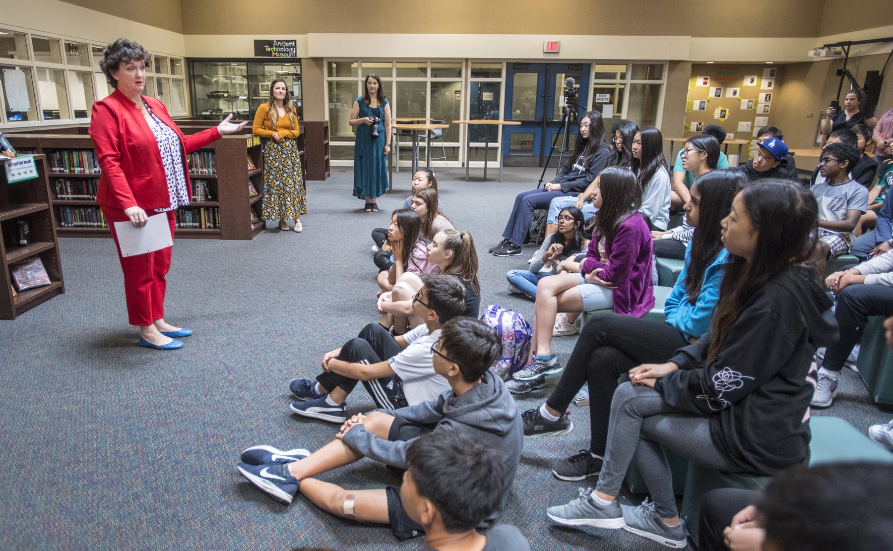 A photo of Katie Porter speaking to middle school students.