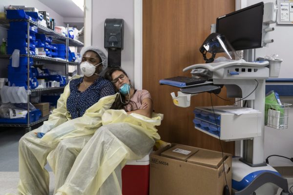 Two members of a medical staff rest in the ICU.