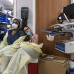 Two members of a medical staff rest in the ICU.