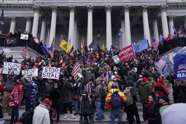 A mob gathers on the steps of the Capitol on January 6.