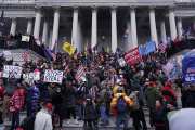 A mob gathers on the steps of the Capitol on January 6.