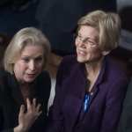 Sens. Kirsten Gillibrand and Elizabeth Warren talk to each other.