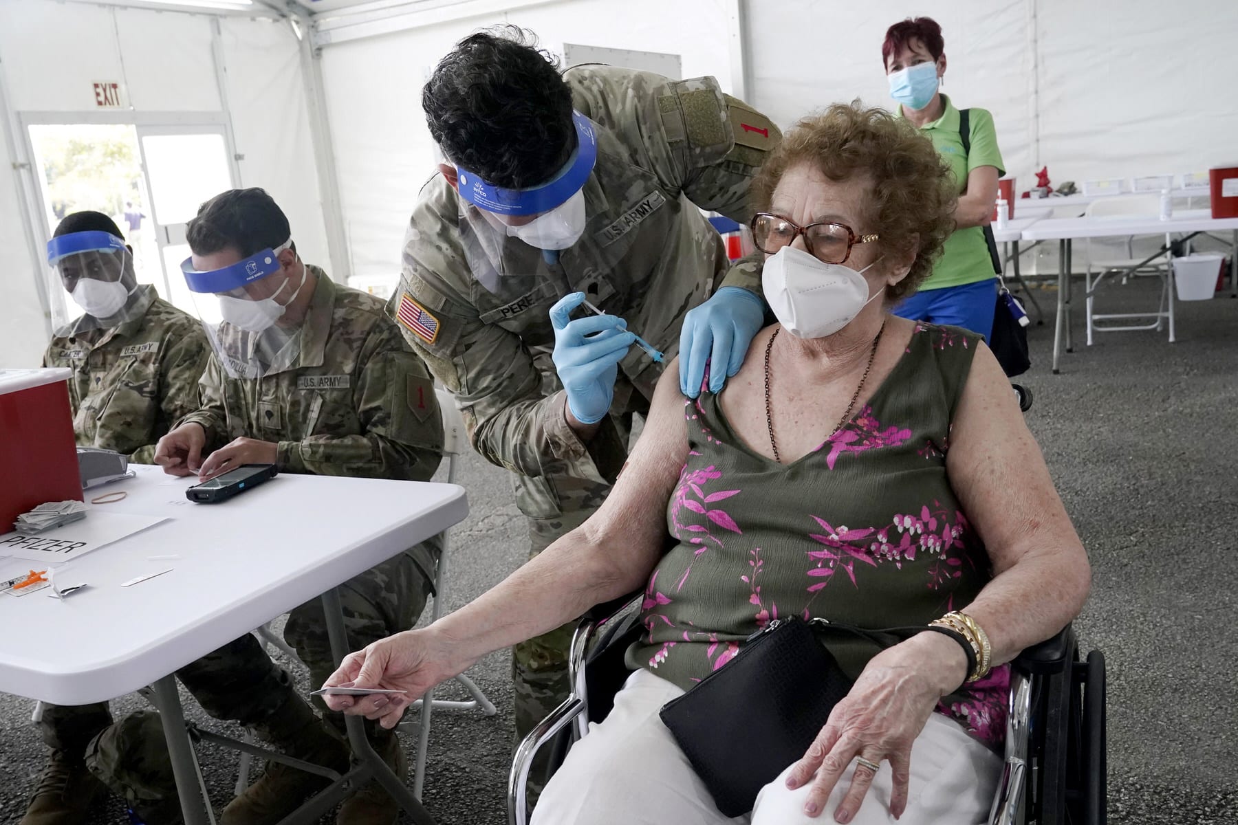 A woman gets her first does of the Pfizer COVID-19 vaccine at a FEMA vaccination site in Florida.