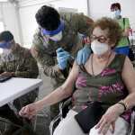A woman gets her first does of the Pfizer COVID-19 vaccine at a FEMA vaccination site in Florida.