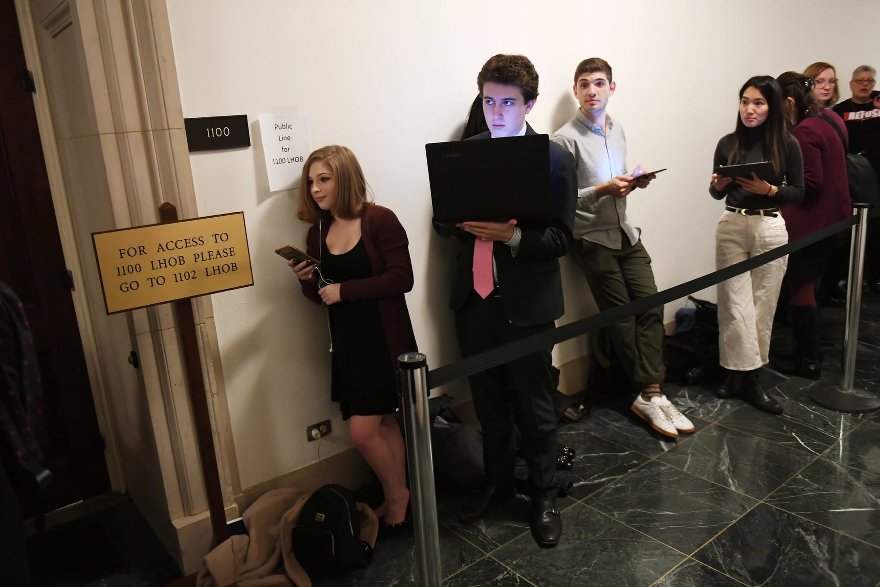 Congressional intern, Sydni Nadler, left, waits in line with others prior to a House Judiciary Committee Impeachment Inquiry hearing.