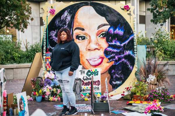 Tamika Palmer, mother of Breonna Taylor, poses for a portrait in front of a mural of her daughter.