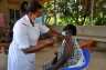 A medical worker administers the COVID-19 vaccine to a recipient at Kasangati Health Center, Wakiso District, Central Region, Uganda.