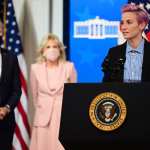 US soccer player Megan Rapinoe (R) speaks, flanked by US President Joe Biden (L) and First Lady Jill Biden during an Equal Pay Day event.