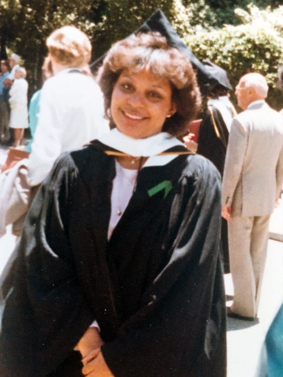 Renel Brooks-Moon in a graduation cap and gown.