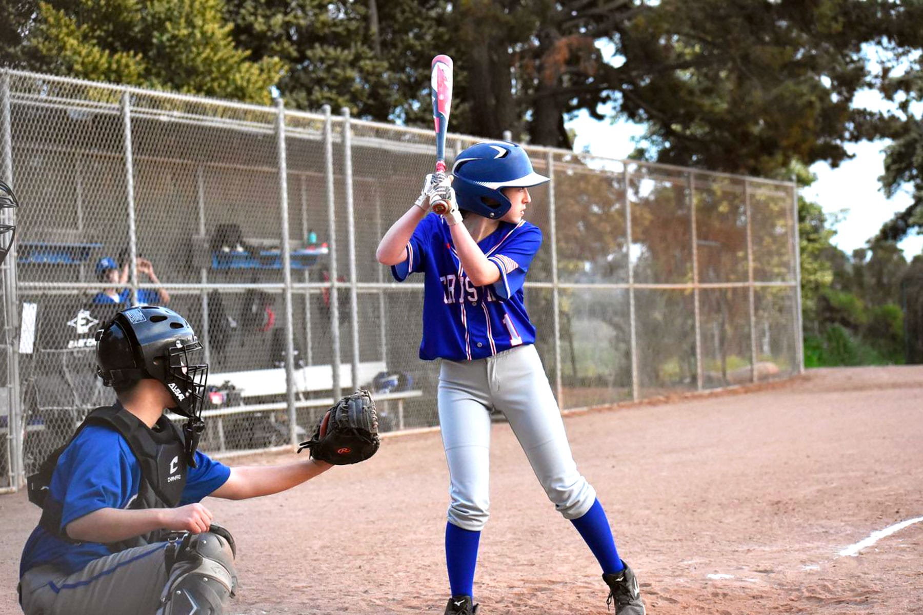 Eliza Schnitzer at bat on a baseball field.