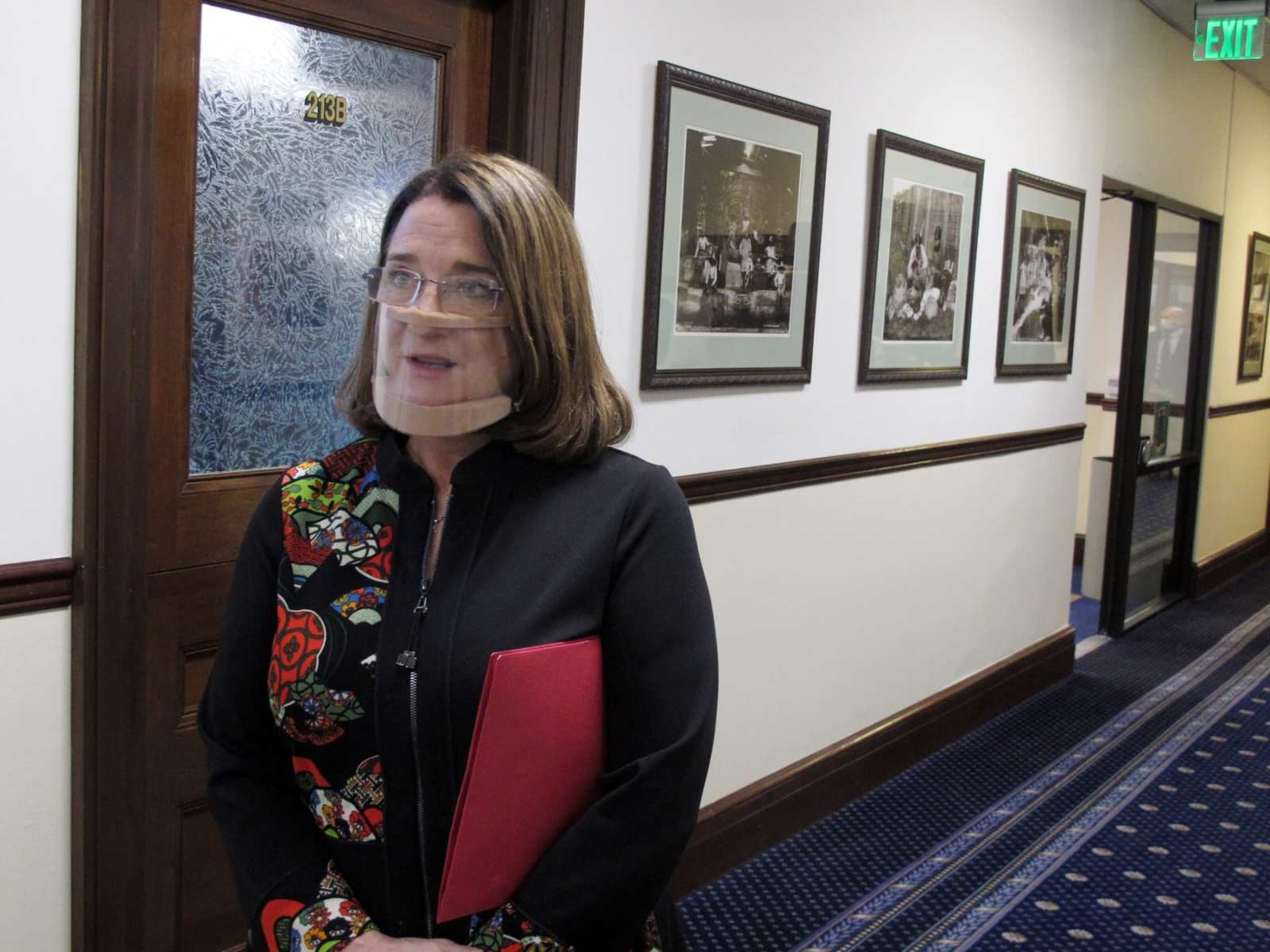 Alaska state Sen. Lora Reinbold, an Eagle River Republican, speaks to reporters in a hallway.