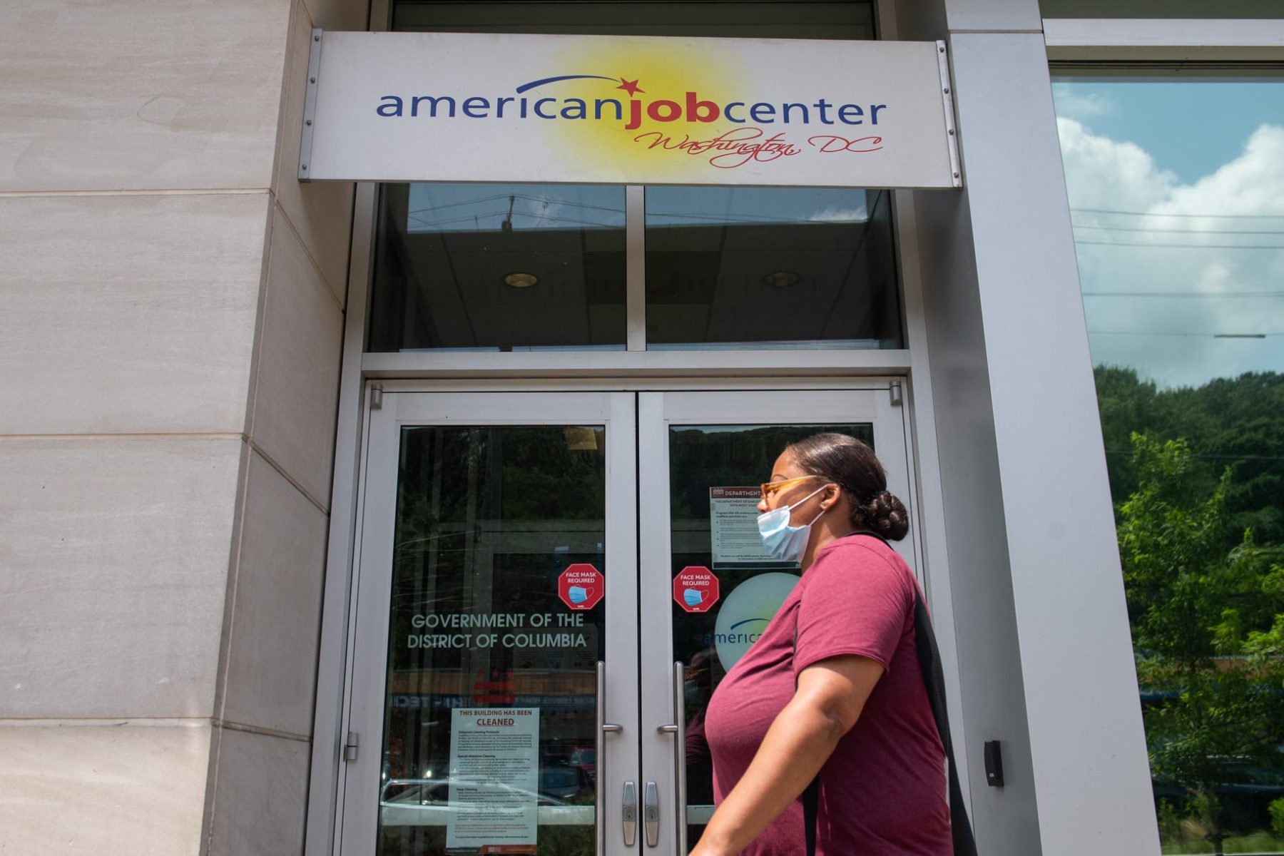 A woman walks past the the DC Department of Employment Services American Job Center.