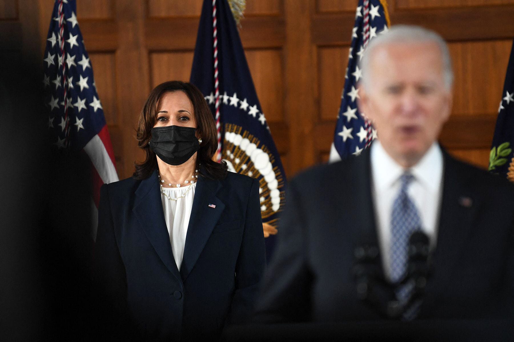 Vice President Kamala Harris stands while President Joe Biden speaks