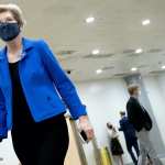 Elizabeth Warren walking while wearing a mask.