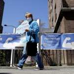 A woman walks near a Covid-19 Vaccination Center in New York City.