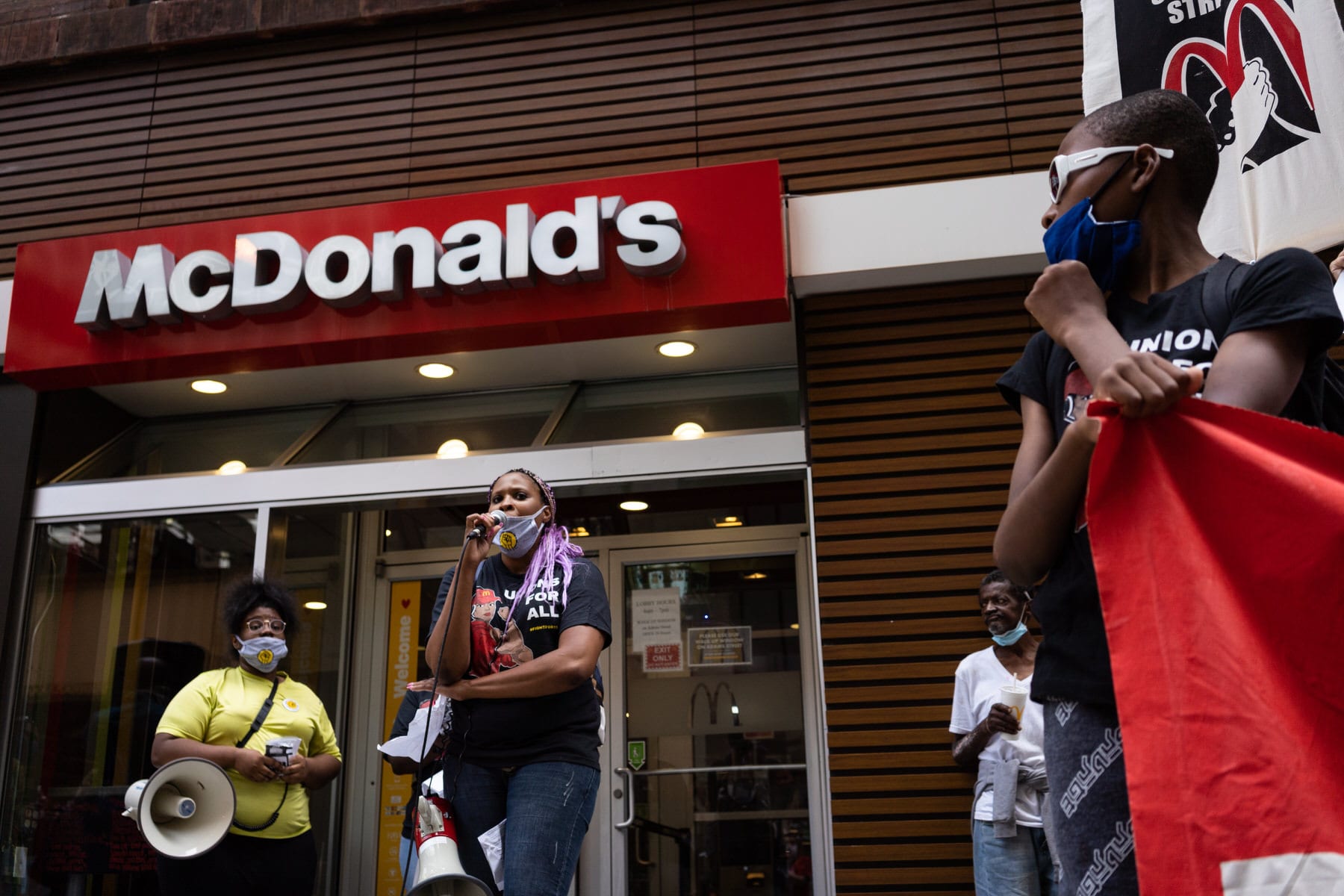 A woman speaks into a megaphone outside of a Chicago McDonald's.