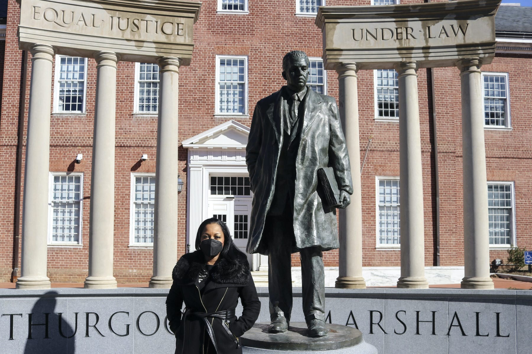 Maryland Del. Vanessa Atterbeary stands in front of a statue of Thurgood Marshall.