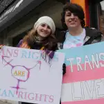 Transgender student Sorrel Rosin (R) poses with a friend February 25 2017 in Chicago as hundreds of transgender supporters protest against the Trump administration's reversal of federal protections