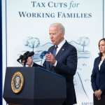US President Joe Biden, with Vice President Kamala Harris (R), speaks about the Child Tax Credit relief payments.