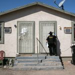 Maricopa County constable knocks on a door before posting an eviction order.