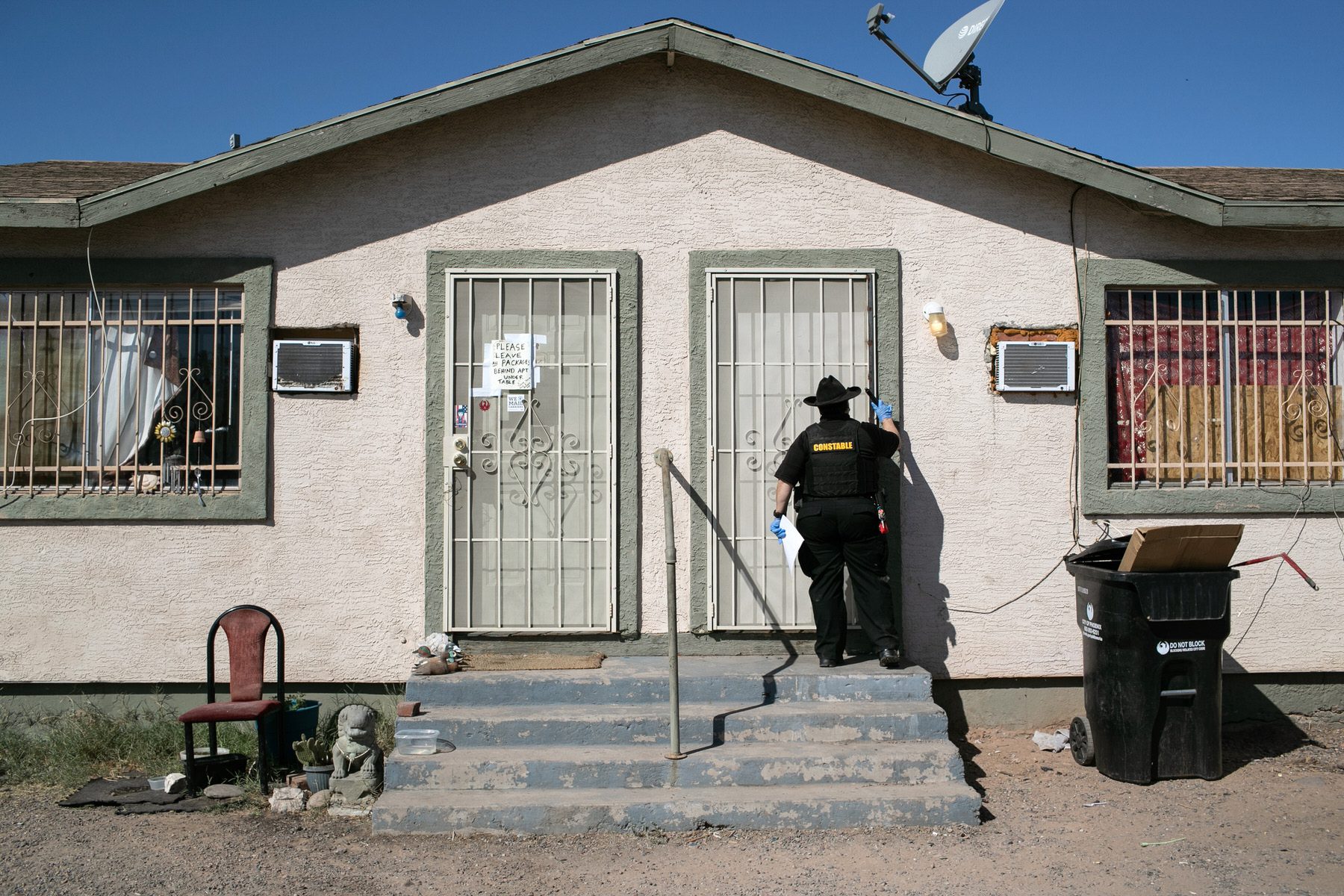Maricopa County constable knocks on a door before posting an eviction order.