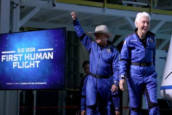 Blue Origin’s New Shepard crew (L-R) Jeff Bezos and Wally Funk arrive for a press conference after flying into space.
