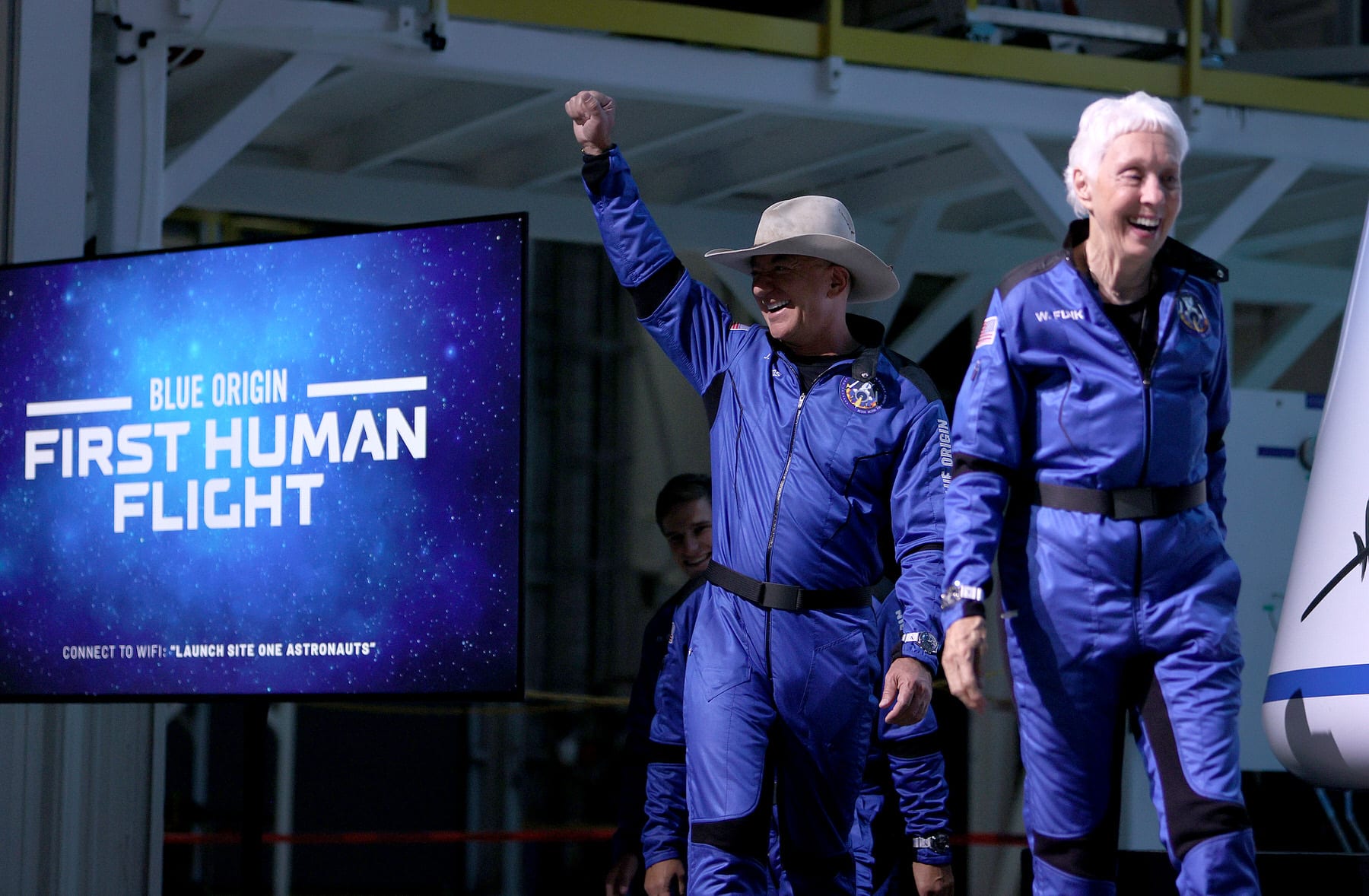 Blue Origin’s New Shepard crew (L-R) Jeff Bezos and Wally Funk arrive for a press conference after flying into space.
